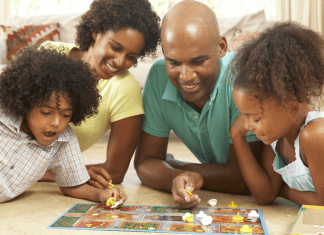 family playing board game. The Omaha Mom