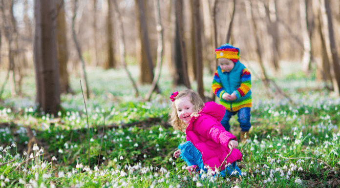things to do in March Omaha Mom Kids in field with white flowers