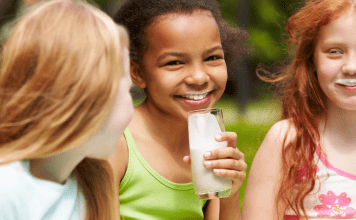 girls smiling and drinking milk Midwest Dairy