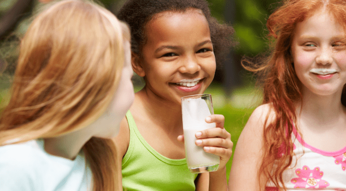 girls smiling and drinking milk Midwest Dairy
