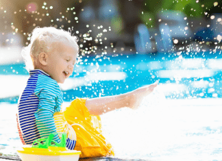 boy splashing in water Omaha swimming pools