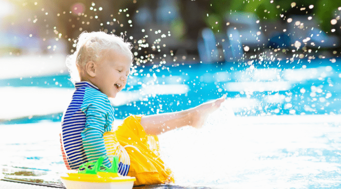 boy splashing in water Omaha swimming pools